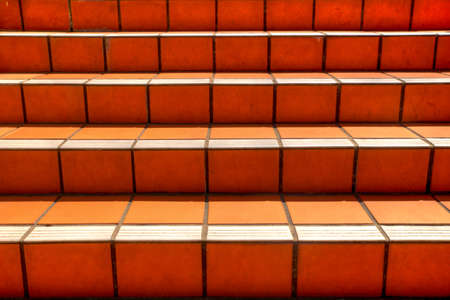 Orange tiled stairs texture going upwardsの写真素材