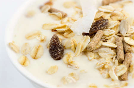 Macro closeup of delicious low-fat yogurt with oats, muesli, bran, almonds and dehydrated fruitの写真素材