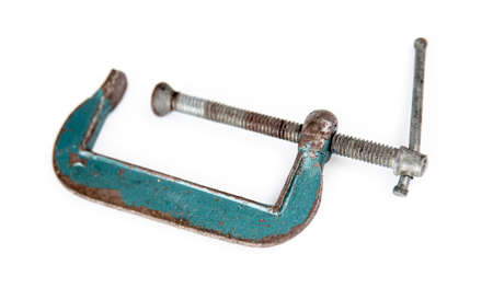 Isolated rusted green vice clamp on white