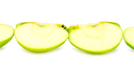 Line of chopped pieces of green appleの写真素材