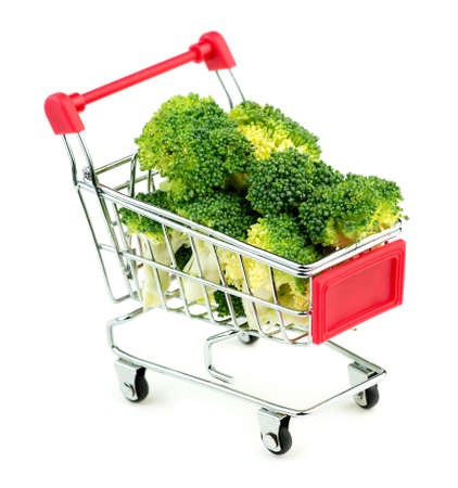 Giant broccoli bunches in market shopping store cart isolated on white backgroundの写真素材