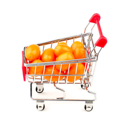 Side view of orange grape tomatoes in shopping cartの写真素材