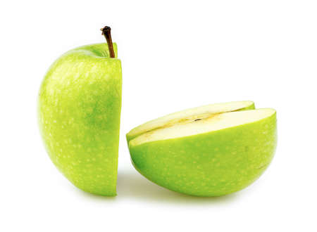 Closeup macro of two halves of a perfectly cut green appleの写真素材