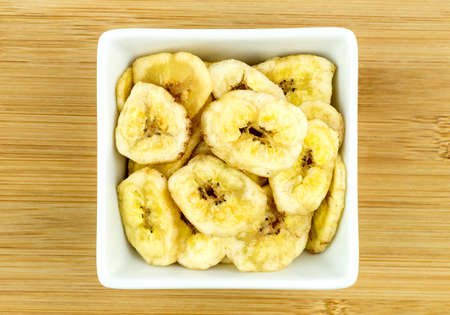 Tasty banana chips in bowlの写真素材