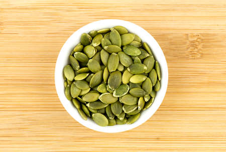 Fresh pumpkin seeds in bowlの写真素材