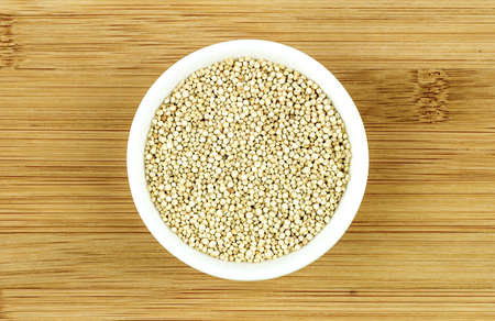 Quinoa seeds in white bowlの写真素材