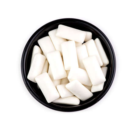 Bowl with pieces of tasty white chewing gumの写真素材