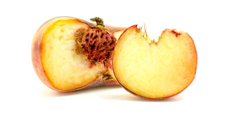 Donut peach fruit with slice and core isolated on whiteの写真素材
