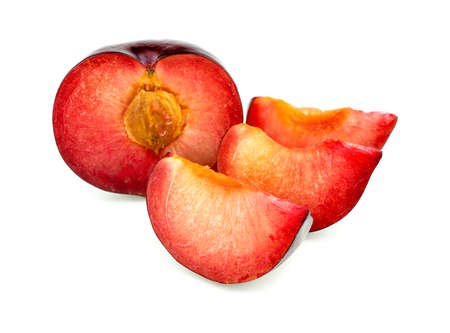 Juicy vibrant tasty fresh plum with slices isolated on whiteの写真素材