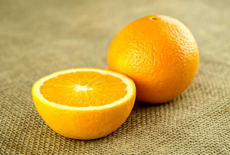 Cut organic orange on rustic backgroundの写真素材