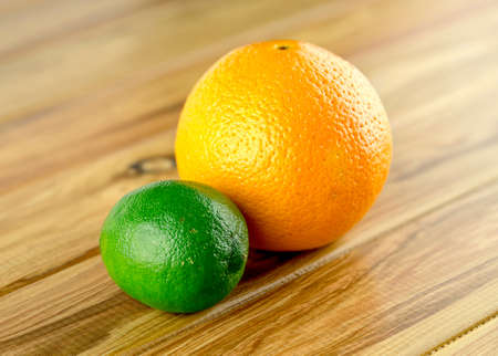 Orange and lime, colorful daytime snackの写真素材