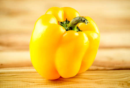 Ripe, organic Yellow capsicum on chopping board