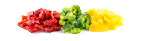 Vibrant red, green and yellow capsicum peppers cut into pieces on whiteの写真素材