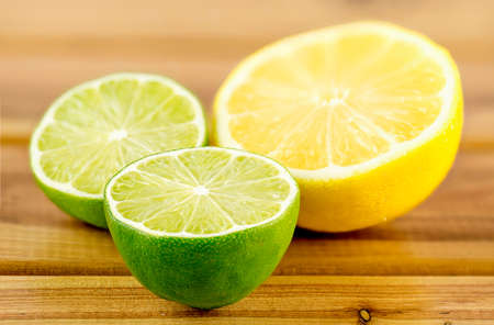 Green and yellow juicy citrus halves, shallow depth of fieldの写真素材