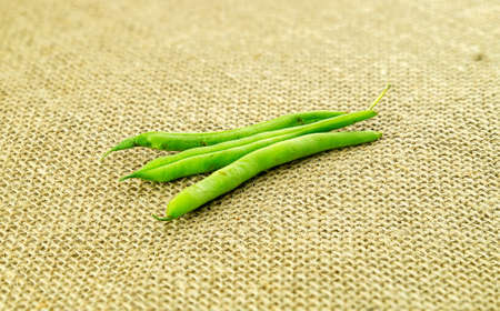 Organic green beans on country style hessian backgroundの写真素材
