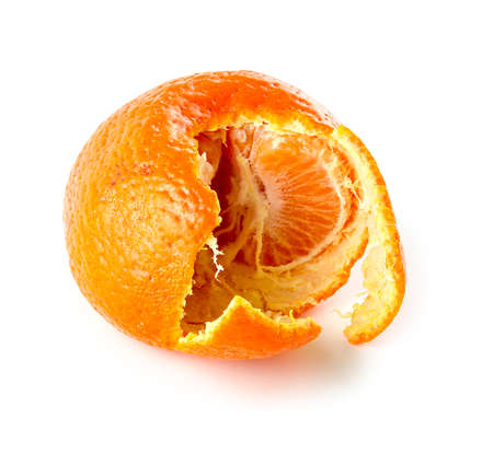 Mandarin orange with semi peeled skin showing segments of juicy fruit insideの写真素材