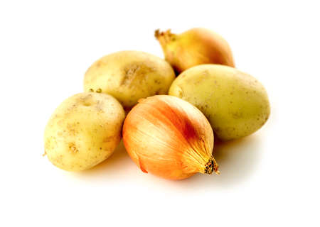 Nutritious unpeeled onions and potatoes isolated on whiteの写真素材