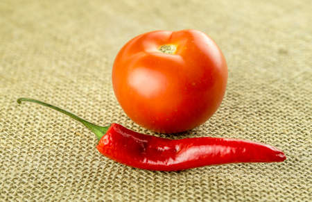 Red spicy chili and succulent tomato ingredientsの写真素材