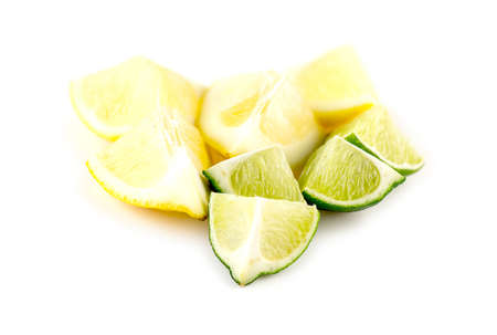 Pieces of cut lemons and limes on white backgroundの写真素材