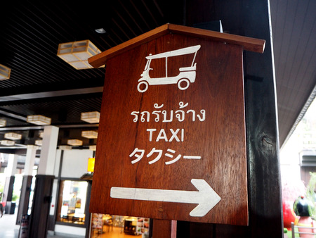 Wooden signpost for Taxi, with arrowsの写真素材