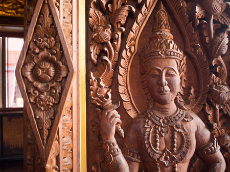 An ancient mural wood carving in Thai temple, Thailandの写真素材