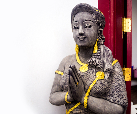 Beautiful hand craft Thai girl statue praying.の写真素材