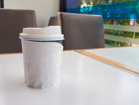 Paper cup of takeaway coffee on the table, Place for your textの写真素材