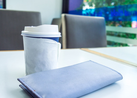 Paper cup of takeaway coffee on the table, Place for your text or logo.の写真素材