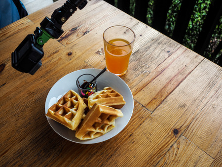 Pieces waffles with chocolate sauce isolated and Orange juice.の写真素材
