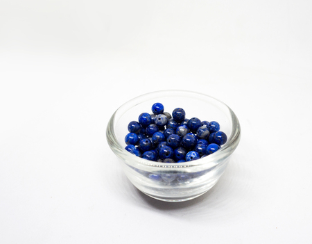 natural lapis lazuli in Glass cup on white background.の写真素材