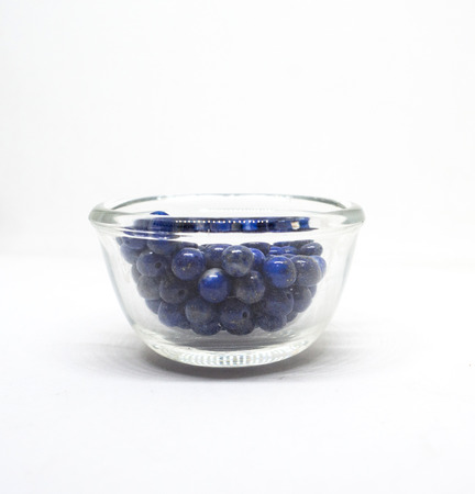 natural lapis lazuli in Glass cup on white background.の写真素材