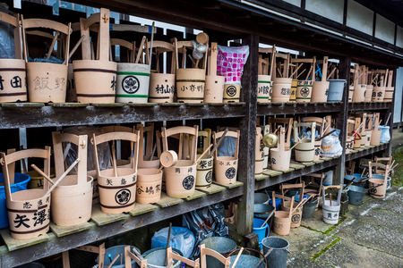Japanese religious bucket and ladle for purifying at the old grave yard.のeditorial素材
