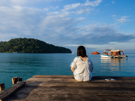 Traveler woman is relaxing on wood bridge in beautiful island, koh kood island, Trat Thailand, Nov 2018.の写真素材