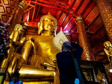 Buddha image in Wat Phanan Choeng Temple, AYUTTHAYA, THAILAND - Nov 2018, Ayutthaya is former capital of Siam (former Thailand).のeditorial素材