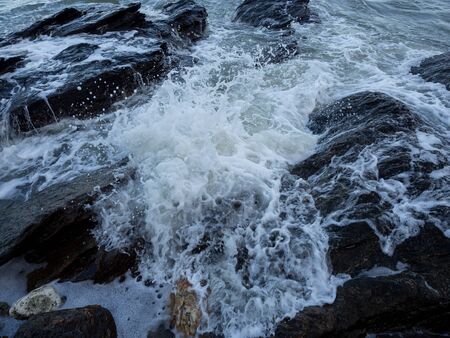Waves coming to the rocky shore.の写真素材