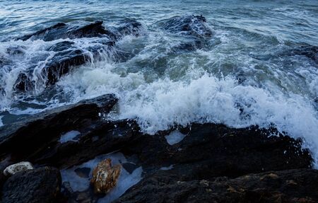 Waves coming to the rocky shore.の写真素材