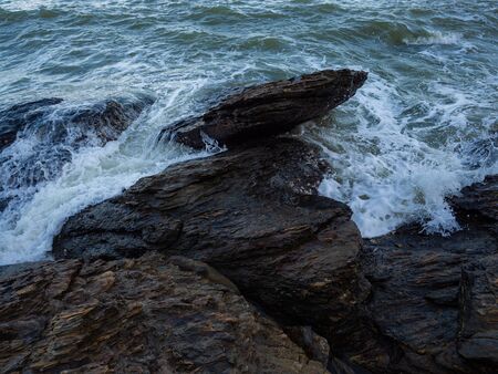 Waves coming to the rocky shore.の写真素材