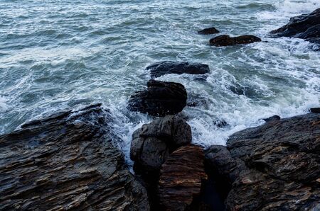Waves coming to the rocky shore.の写真素材