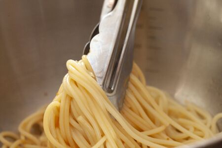 Mix the boiled spaghetti and sauce in Tongの写真素材