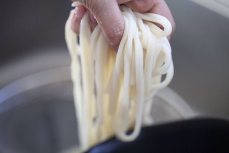 Cooking udon with Japanese foodの写真素材