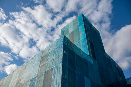 Building covered with blue sheet under constructionのeditorial素材