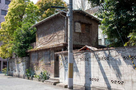 Old Japanese house with dead ivy crawling on the wall/ April 4, 2020 Osaka City, Osaka Prefecture, Japanのeditorial素材