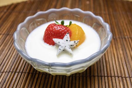 Milk pudding topped with fruitの写真素材