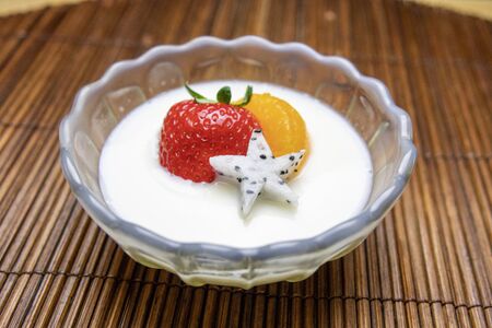 Milk pudding topped with fruitの写真素材