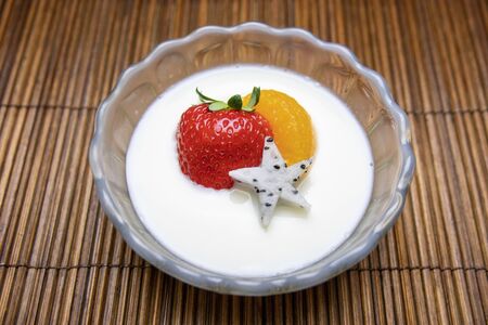 Milk pudding topped with fruitの写真素材