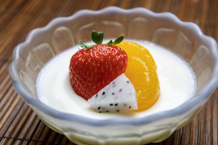 Milk pudding topped with fruitの写真素材