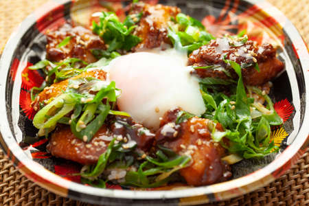 A grilled chicken bowl of prepared food in a plastic containerの写真素材