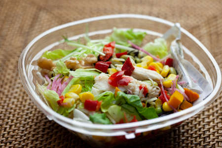 Close up of vegetable salad with chicken on topの写真素材