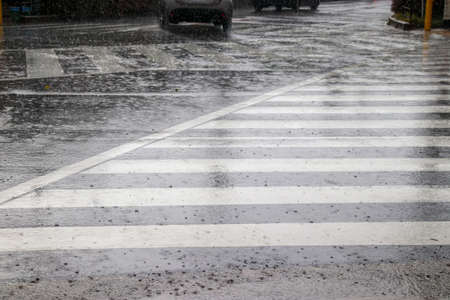Crosswalk at an intersection in heavy rain