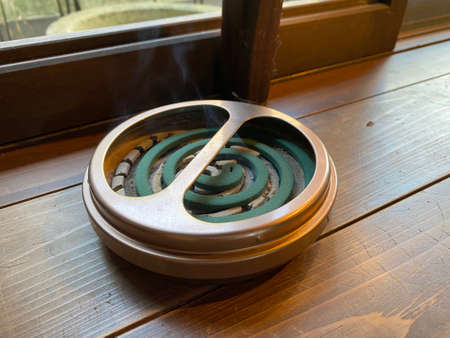 Mosquito coils incense sticks placed on a wooden floor.の写真素材